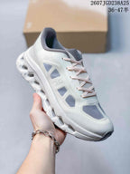 Angled side view of the sneaker showing the On branding, laces, upper panels, and sole.