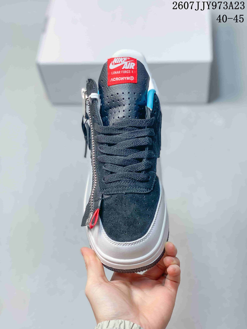 Front view showing the perforated dark toe box, black laces, red tongue label, and side zipper.