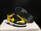 Three-quarter view showing one sneaker upright and the other tilted to reveal the black patterned outsole.
