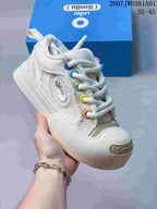 Close-up of an off-white Ouder sneaker with colorful eyelets and thick rope laces.