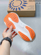 Outsole view of the ASICS running shoe showing orange tread sections and a white sole