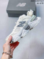 Side profile showing the mesh upper, large navy New Balance branding, heel strap, and sculpted sole.