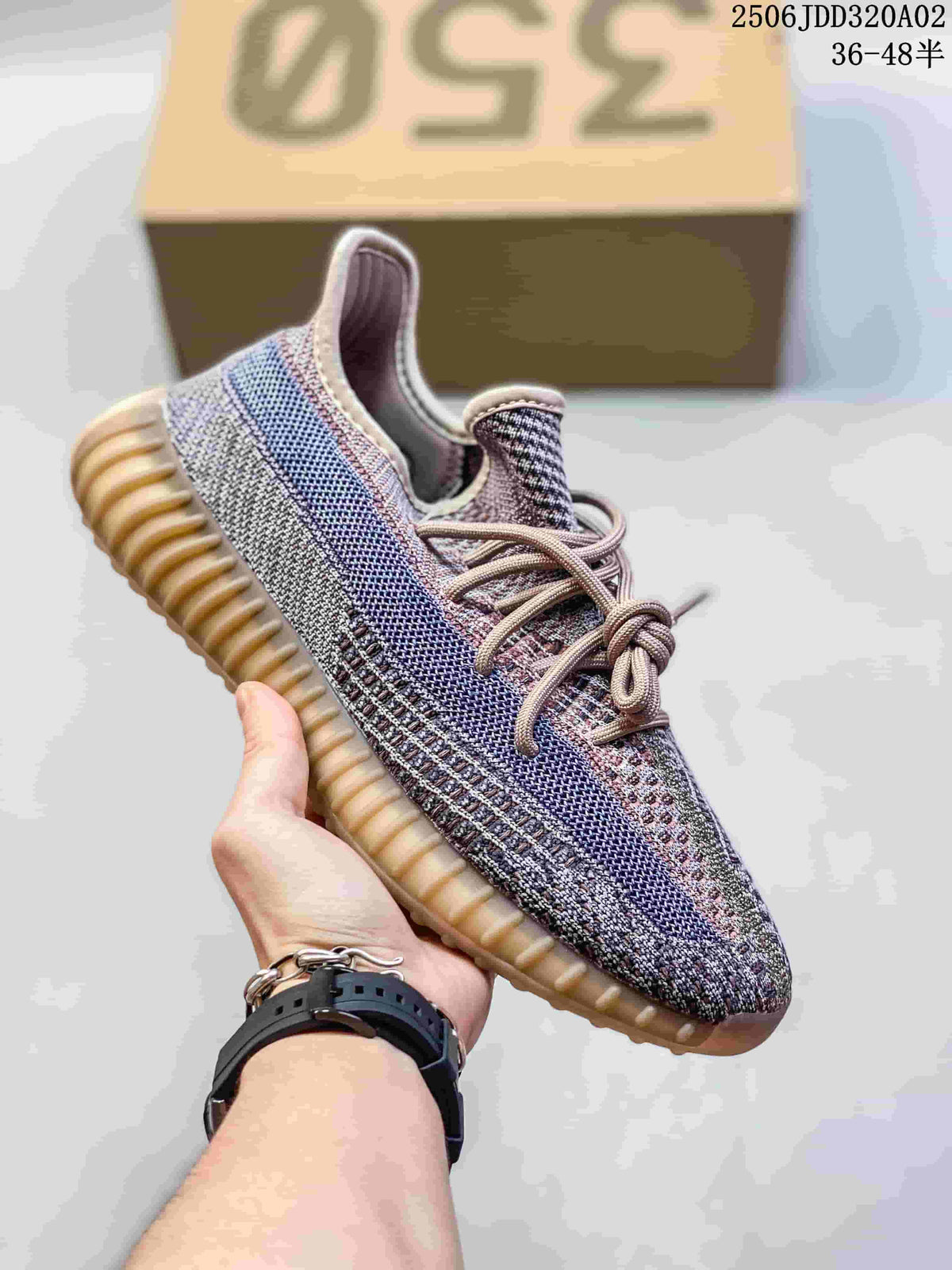 Light multicolor knit sneaker with blue and pink accents, pale laces, and a gum-colored ribbed sole.