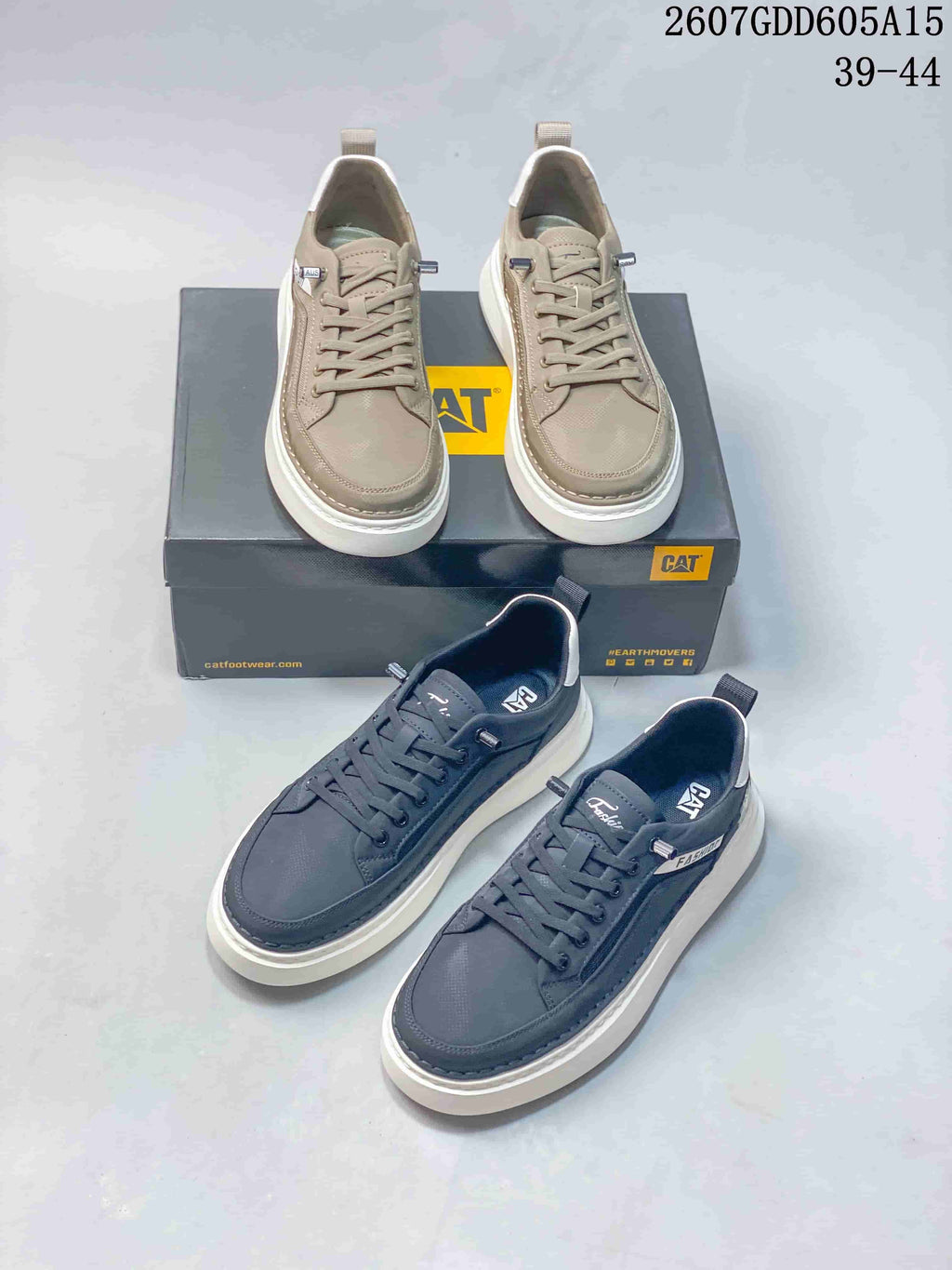 Taupe and charcoal CAT sneakers shown together with branded boxes and low-profile lace-up construction.