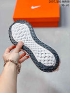 Close view of the shoe outsole showing a textured white center tread and dark perimeter rubber sections.
