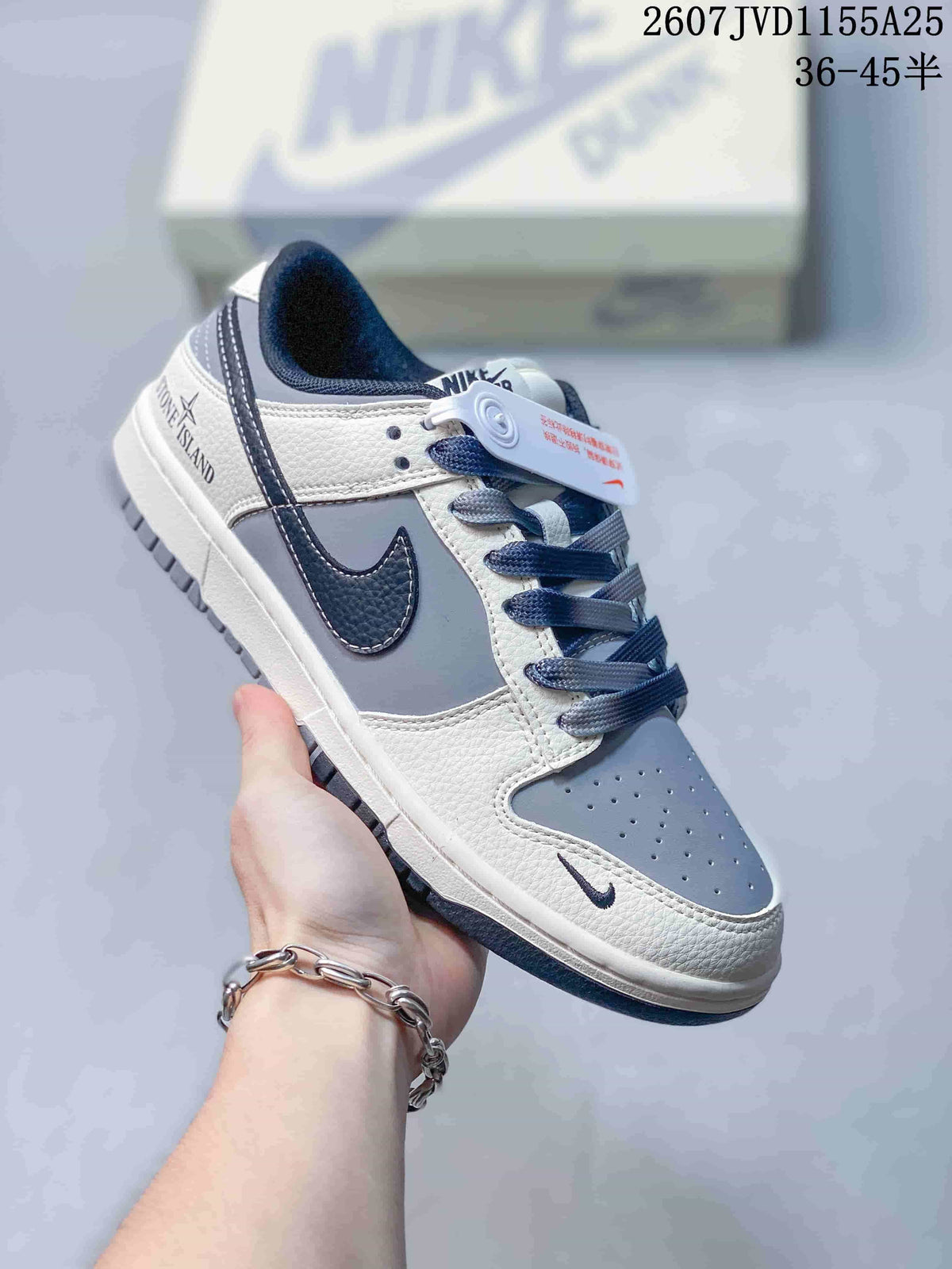 Angled side view of the Nike SB Dunk Low Pro sneaker showing its grey, white and dark navy color blocking and low-top profile.