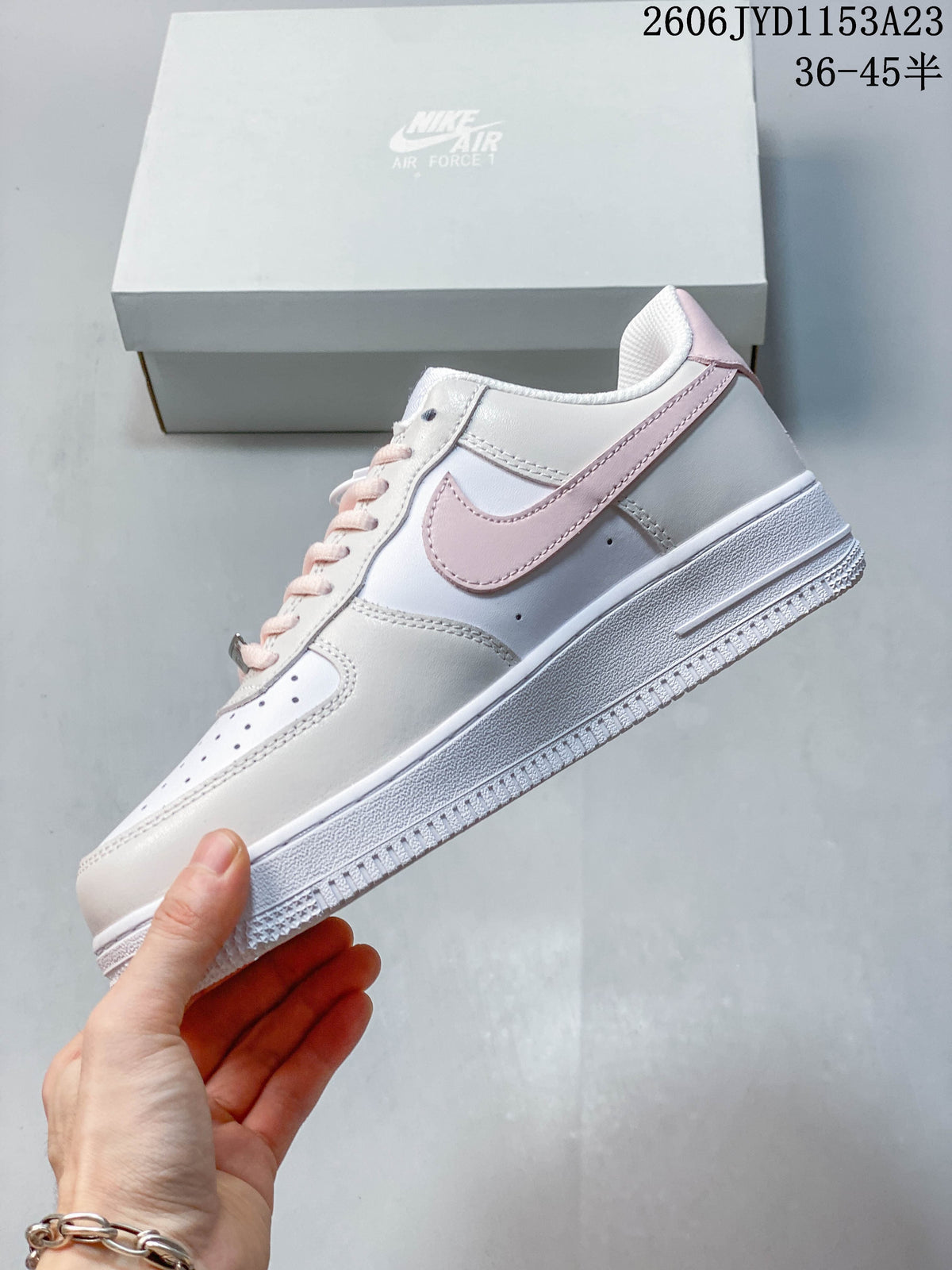 Side profile of a white and pale grey low-top sneaker with a blush-pink Swoosh; image overlay shows 36–45.5.