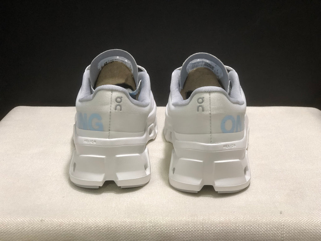 Rear view of the pair showing On branding, light blue heel graphics, and the structured white outsole.