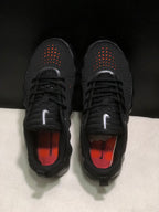 Top view of the pair showing perforated toe boxes, black laces, and orange insoles.
