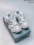 Pair of gray New Balance 9060 sneakers displayed on a shoebox, with the style code and size range visible above.