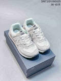 Pair of white and grey New Balance 574 sneakers displayed on a New Balance shoe box; image text shows style code 2607JGD1095A25 and size range 36–45.5.