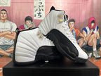 Pair of white and black Jordan 12 sneakers shown from the side.