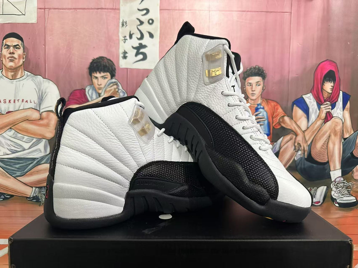 Pair of white and black Jordan 12 sneakers shown from the side.