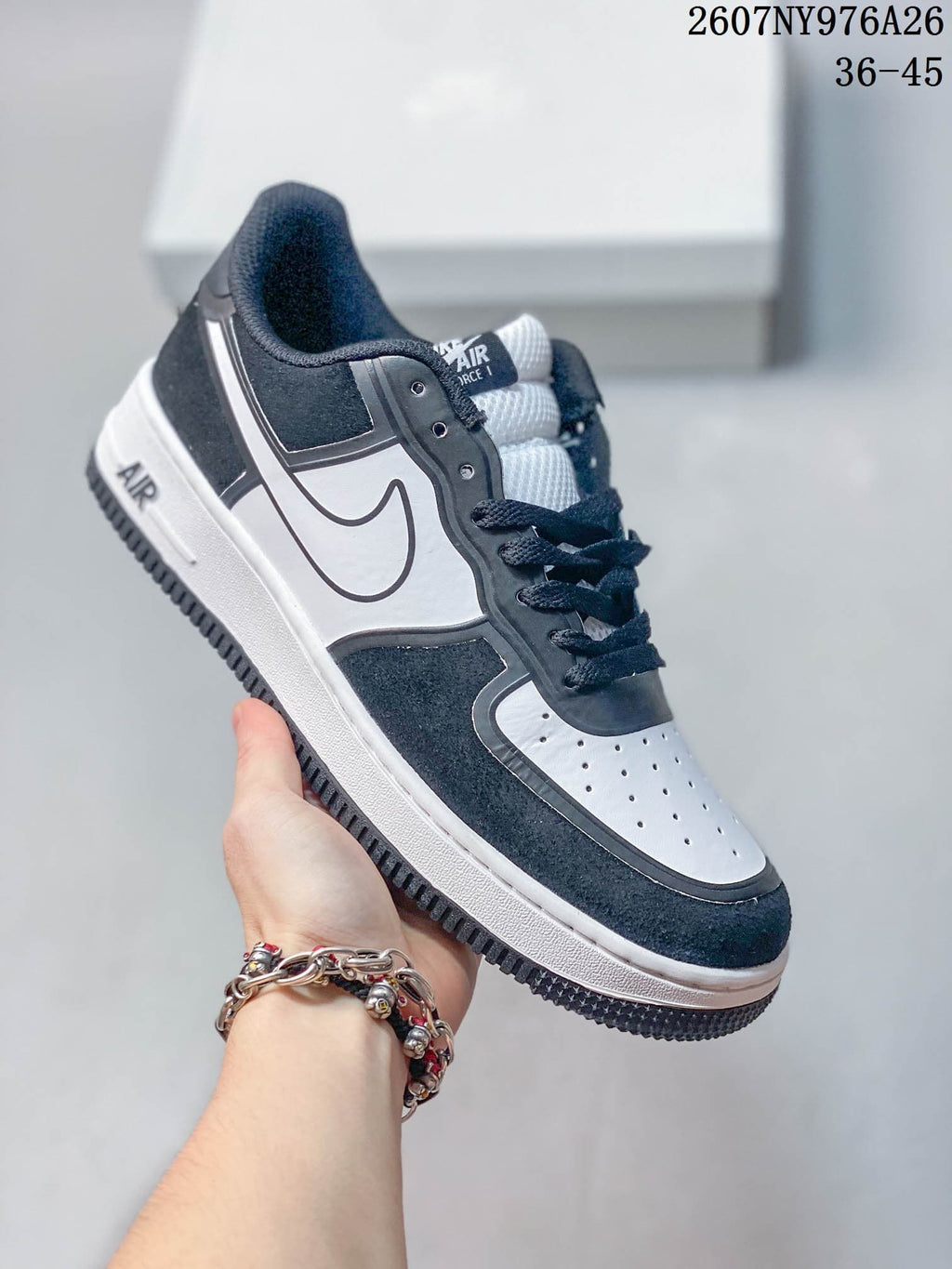 White, black and gray Nike Air Force 1 '07 LV8 sneaker with contrasting side panels.