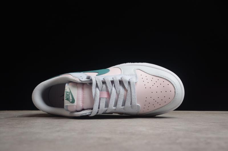 Top view showing the pale pink perforated toe, white laces and padded collar.