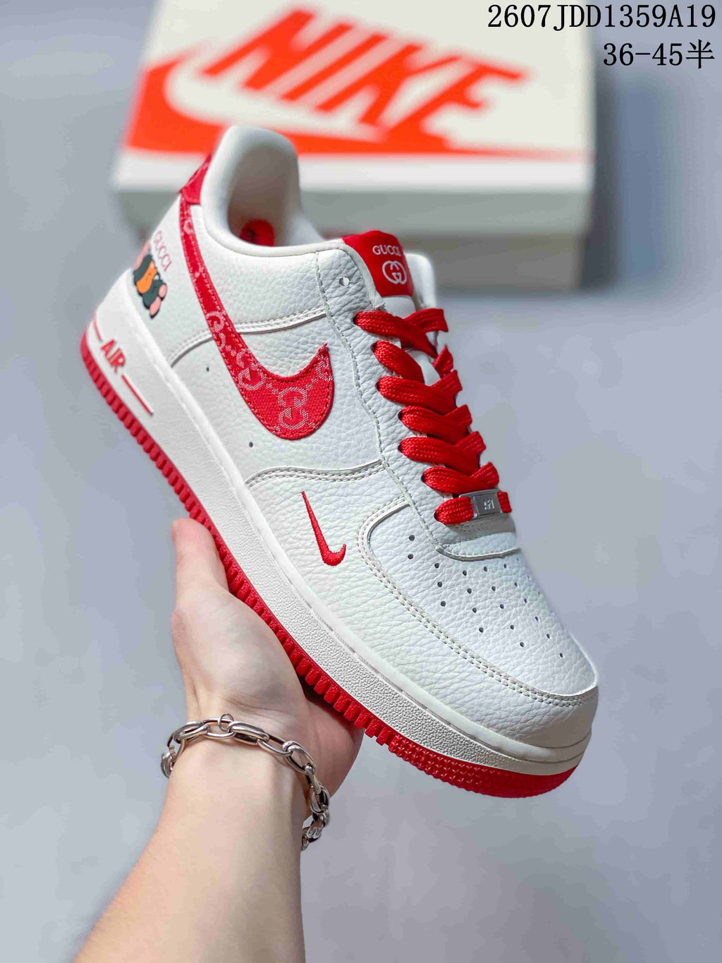 Angled side view of the white and red sneaker showing the patterned side panel, red laces, and low-top construction.