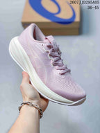 Angled side view of the pink and white ASICS sneaker, showing the knit upper, lace system, and cushioned midsole.