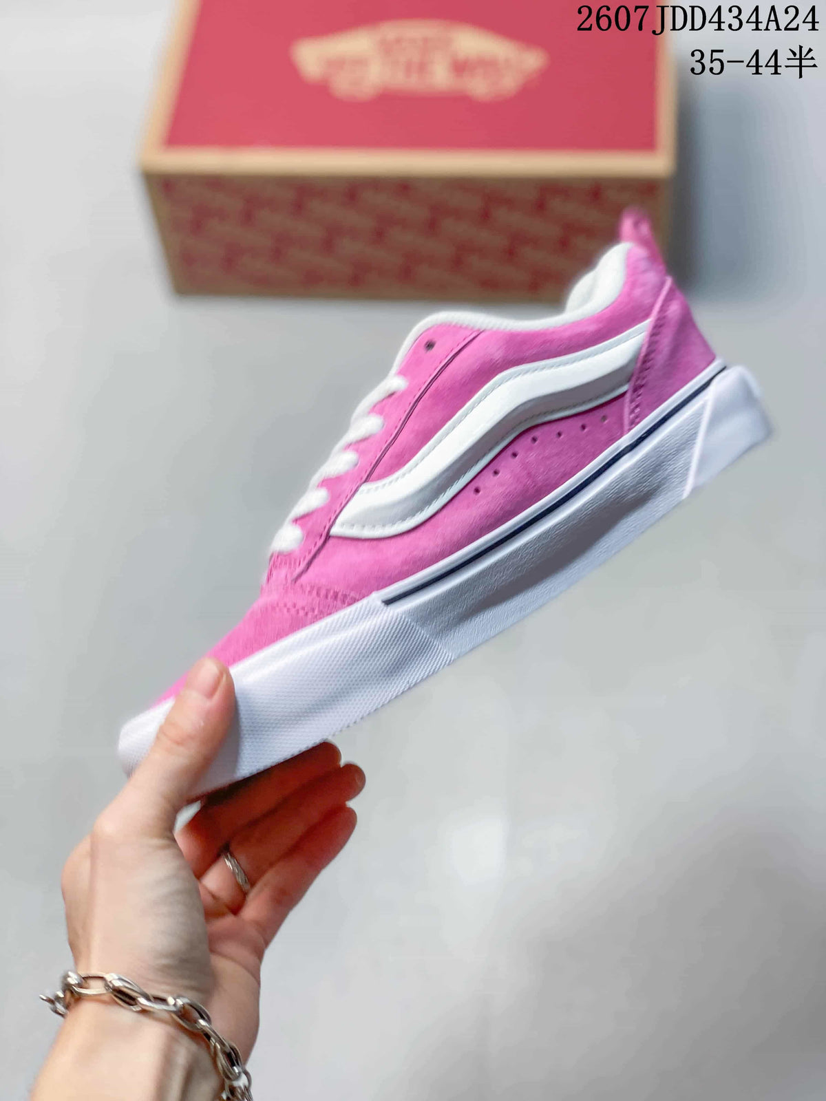 Side profile of the pink low-top sneaker with a white side stripe and white midsole.