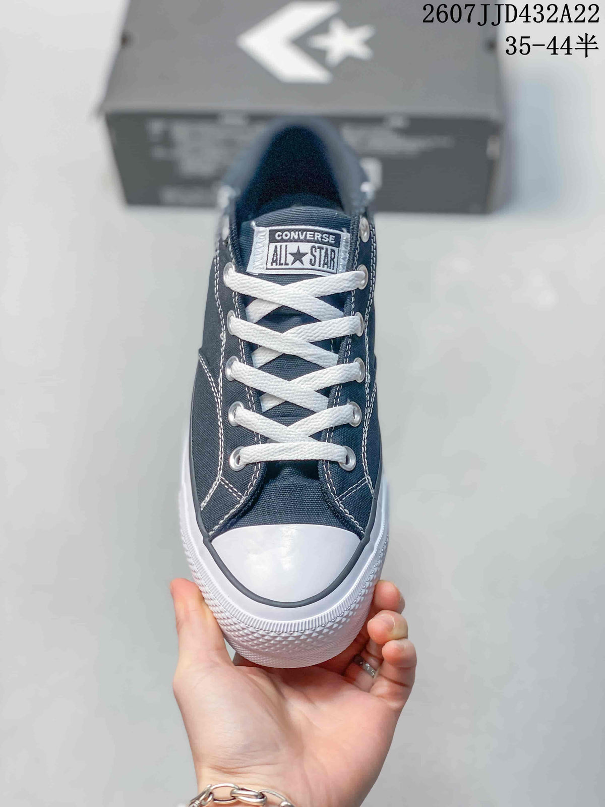 Front view showing the white laces, branded tongue label, rubber toe cap and contrast stitching.