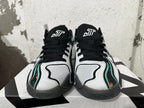 Front view of black, white, and green Jordan basketball shoes with floral-patterned side accents.