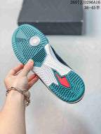Bottom view showing the teal and white rubber outsole with textured traction patterns.