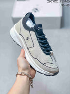 Angled side view of the off-white sneaker with dark laces, contrast trim, side logo, and raised sole.
