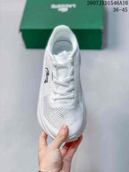 Top view of the white lace-up sneaker showing the perforated-looking forefoot pattern and rounded toe.