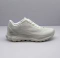 Side view of an all-white Alo low-top sneaker with a textured upper and layered sole.