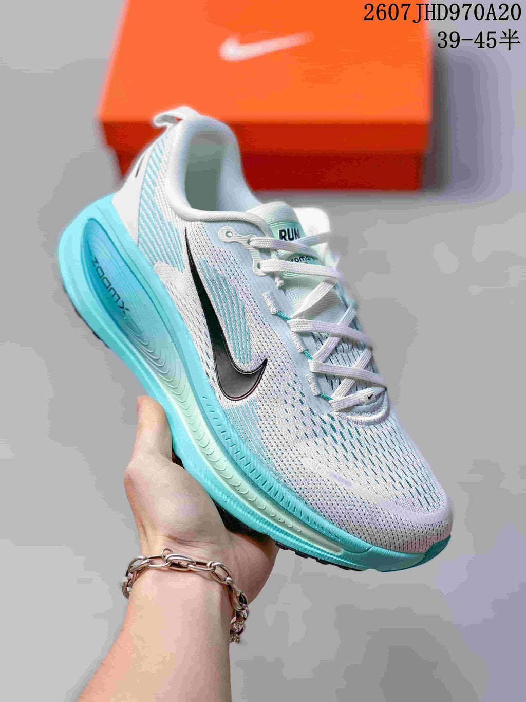 Angled side view of a white and turquoise Nike Structure Plus sneaker showing the black Swoosh, lace-up upper, and sculpted turquoise midsole.