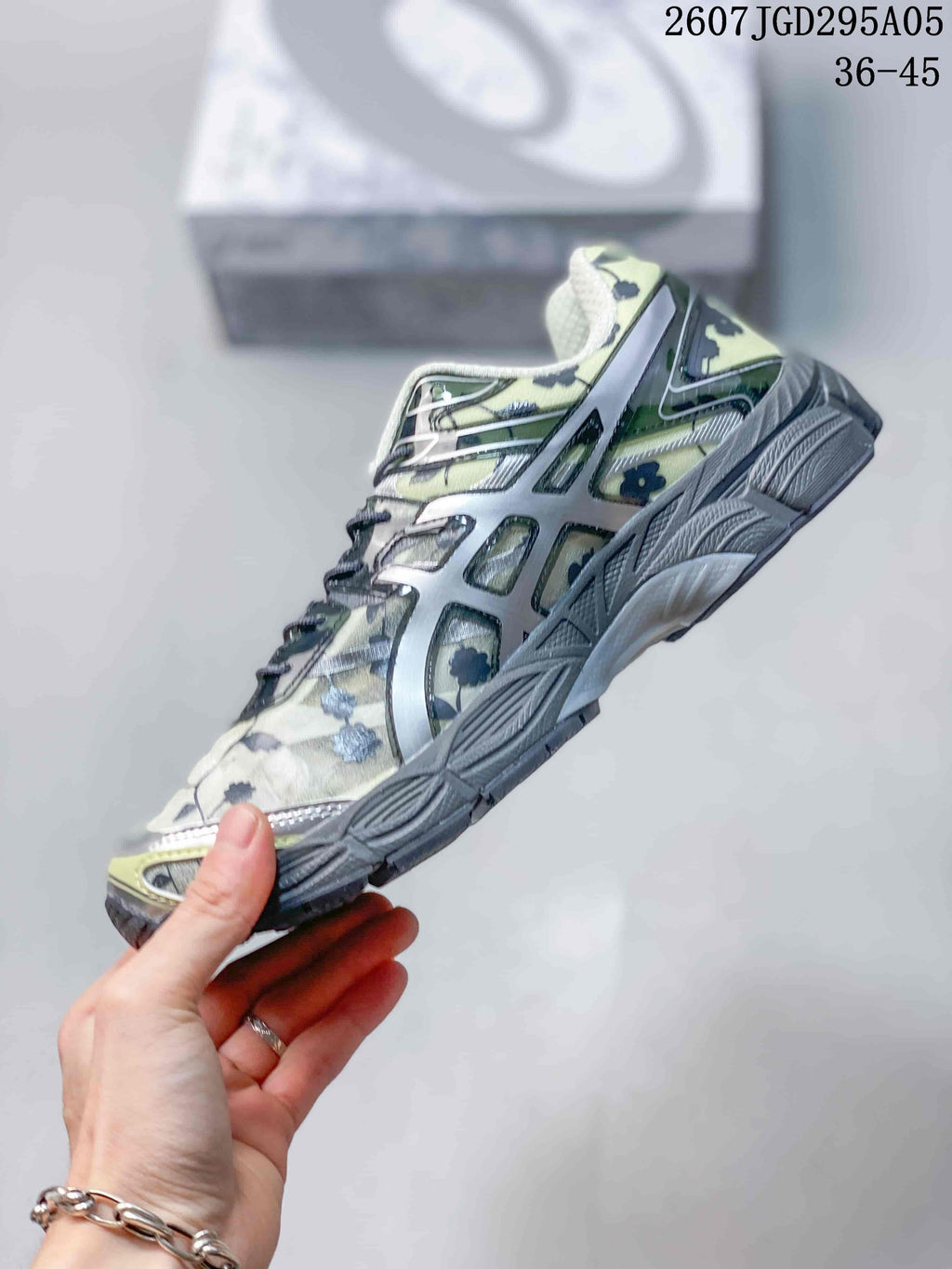 Side view of the sneaker showing the floral upper, layered side detailing, lace system, and segmented sole.