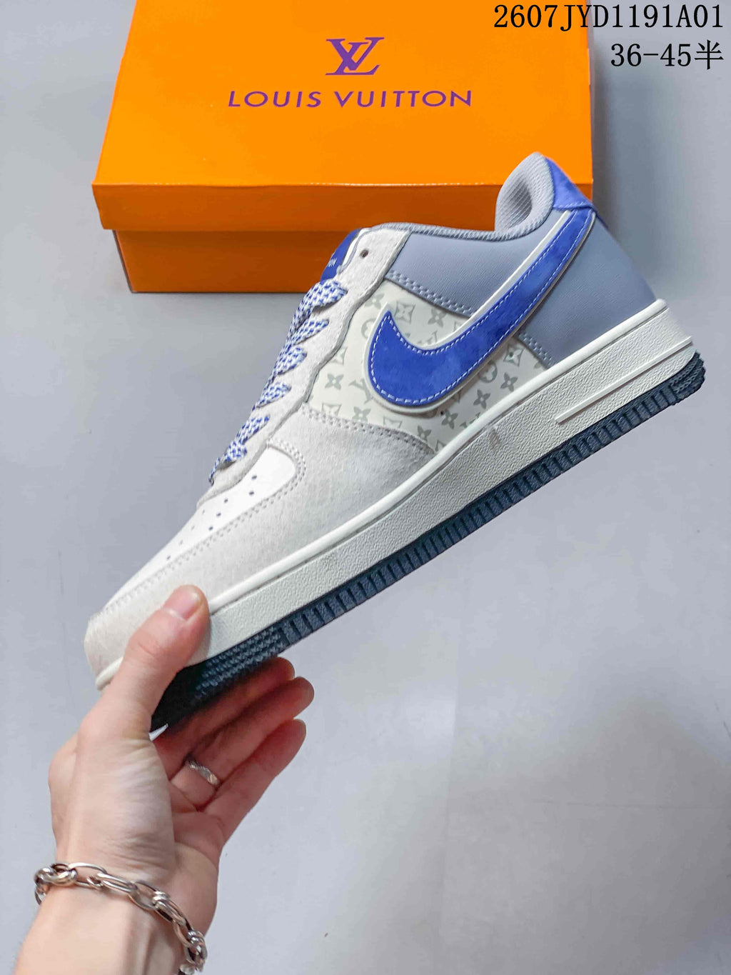 Side view highlighting blue accents, gray patterned panels and a dark outsole.