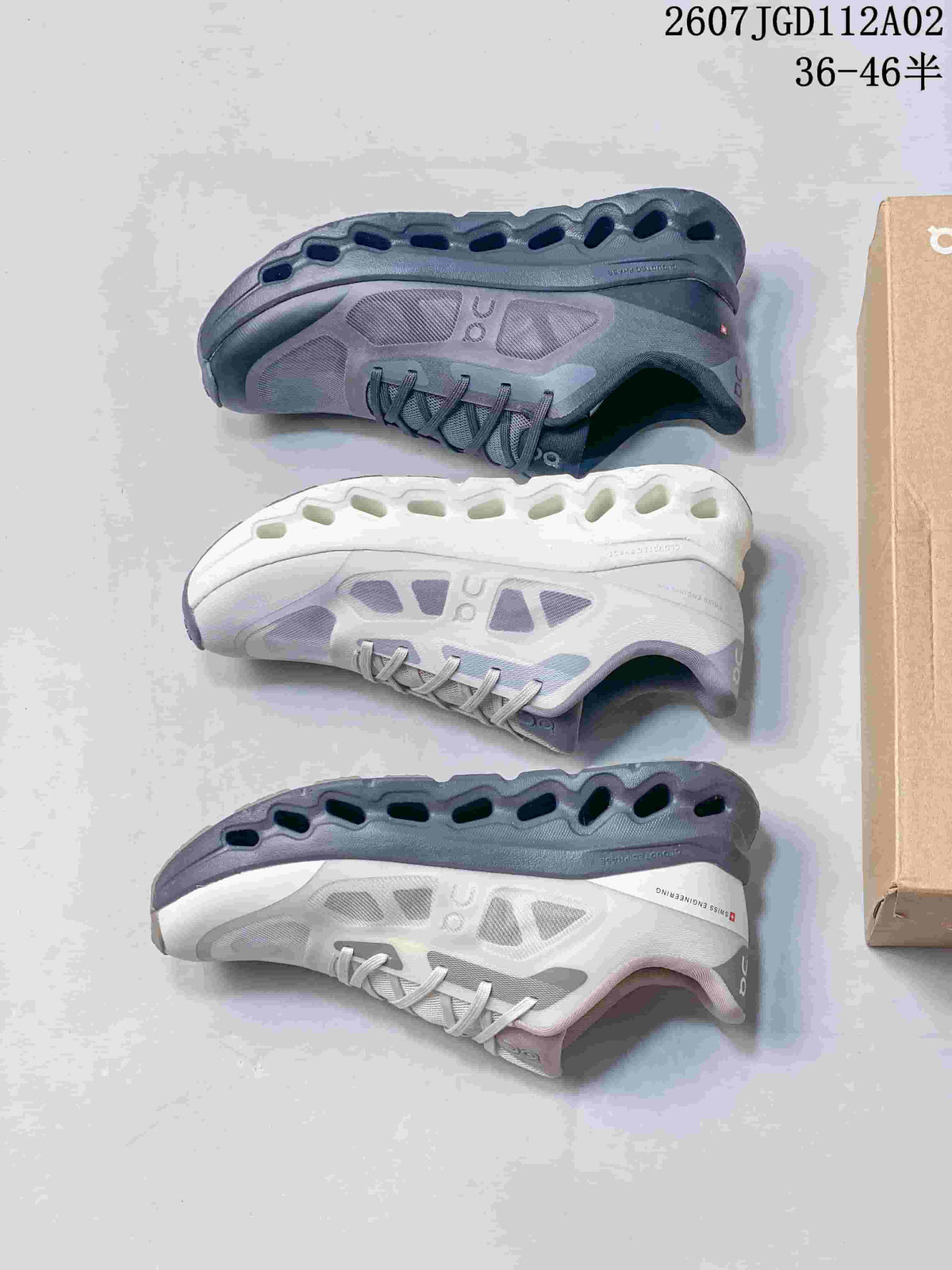 Pair of white and grey Cloudtilt Remix sneakers with contrasting grey soles