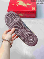 Close-up of the burgundy-colored patterned outsole and red horse-themed shoe box