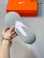 Bottom view showing the sneakers' segmented patterned outsole.