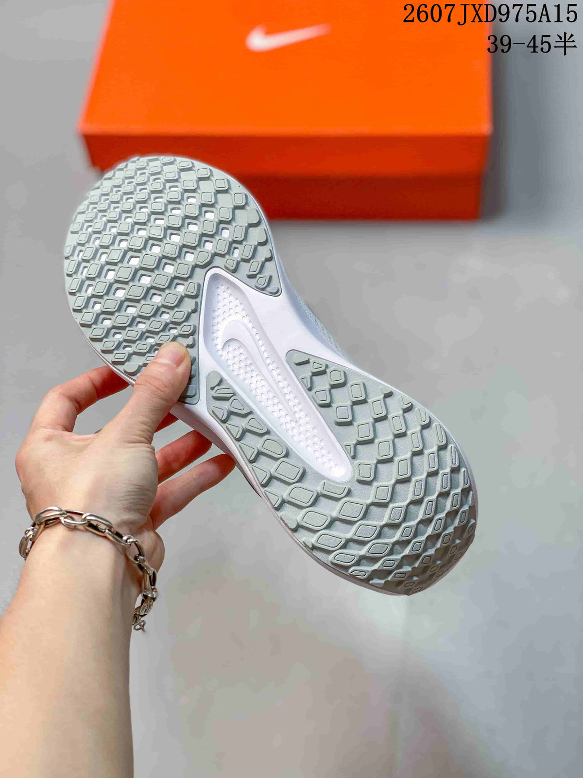 Bottom view showing the sneakers' segmented patterned outsole.
