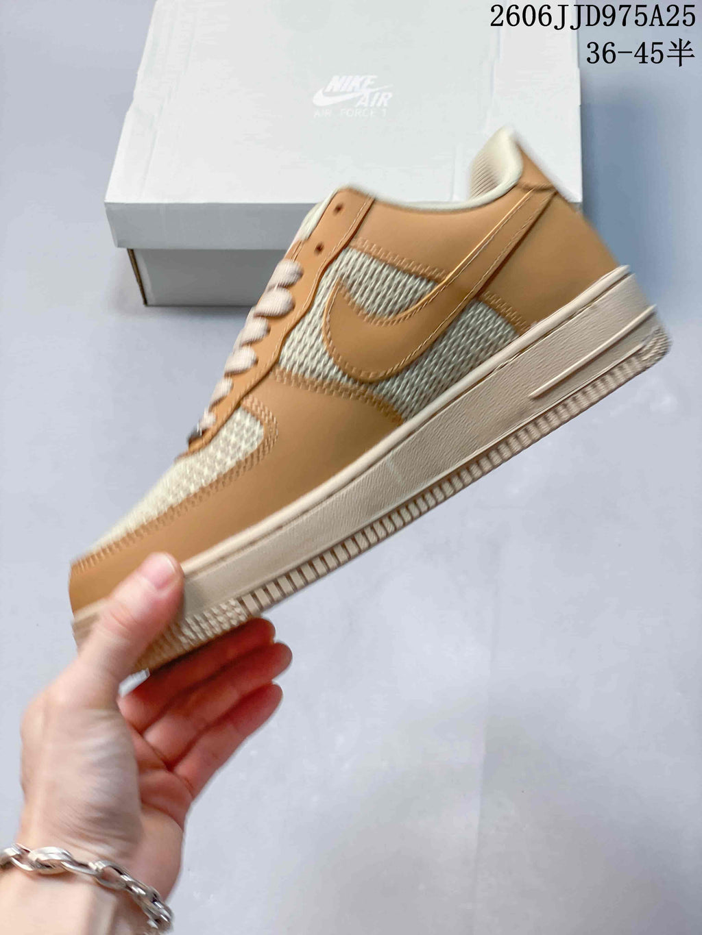 Side profile of the low-top sneaker showing the tan overlay panels, woven-texture side sections, tonal swoosh detail, and cream outsole.