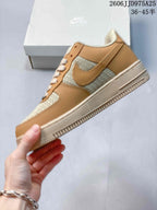 Side profile of the low-top sneaker showing the tan overlay panels, woven-texture side sections, tonal swoosh detail, and cream outsole.