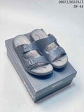 Black ECCO double-buckle slide sandals displayed on an ECCO shoebox.