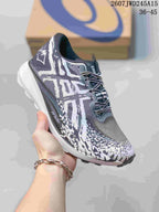 Close-up of a black, white and gray ASICS sneaker with patterned upper, black laces and white midsole.