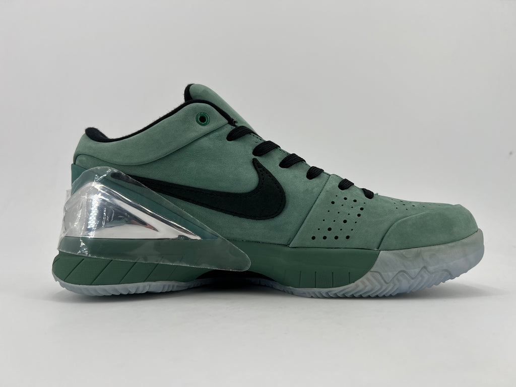 Side profile of the green shoe with black Swoosh and translucent outsole