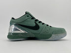 Side profile of the green shoe with black Swoosh and translucent outsole