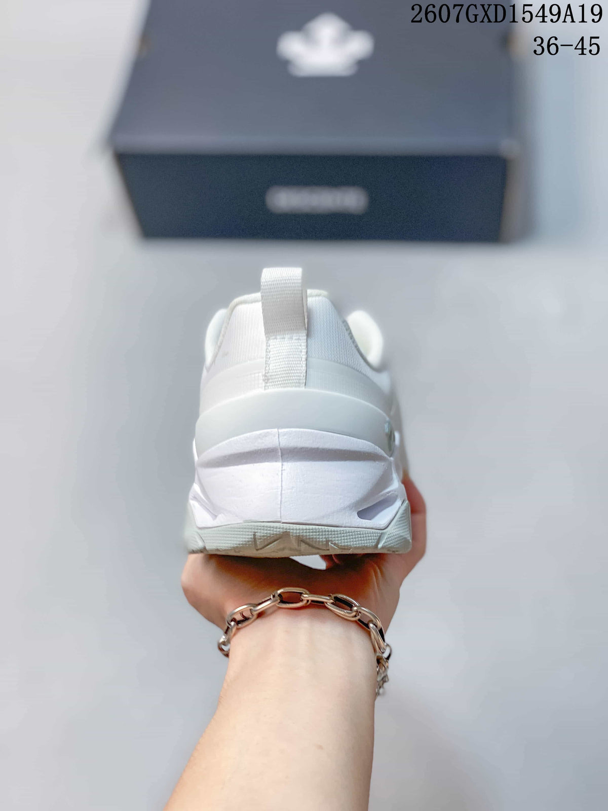 Rear view of the white sneaker showing the heel structure and pull tab.