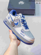 Close-up of a white and blue Nike Air Force 1-style sneaker with blue laces, blue outsole and a Nike Air Force 1 shoe box behind it.