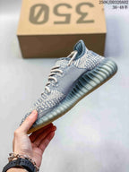 Side profile showing the knit-look upper, contrasting stripe, laces, and ribbed outsole.