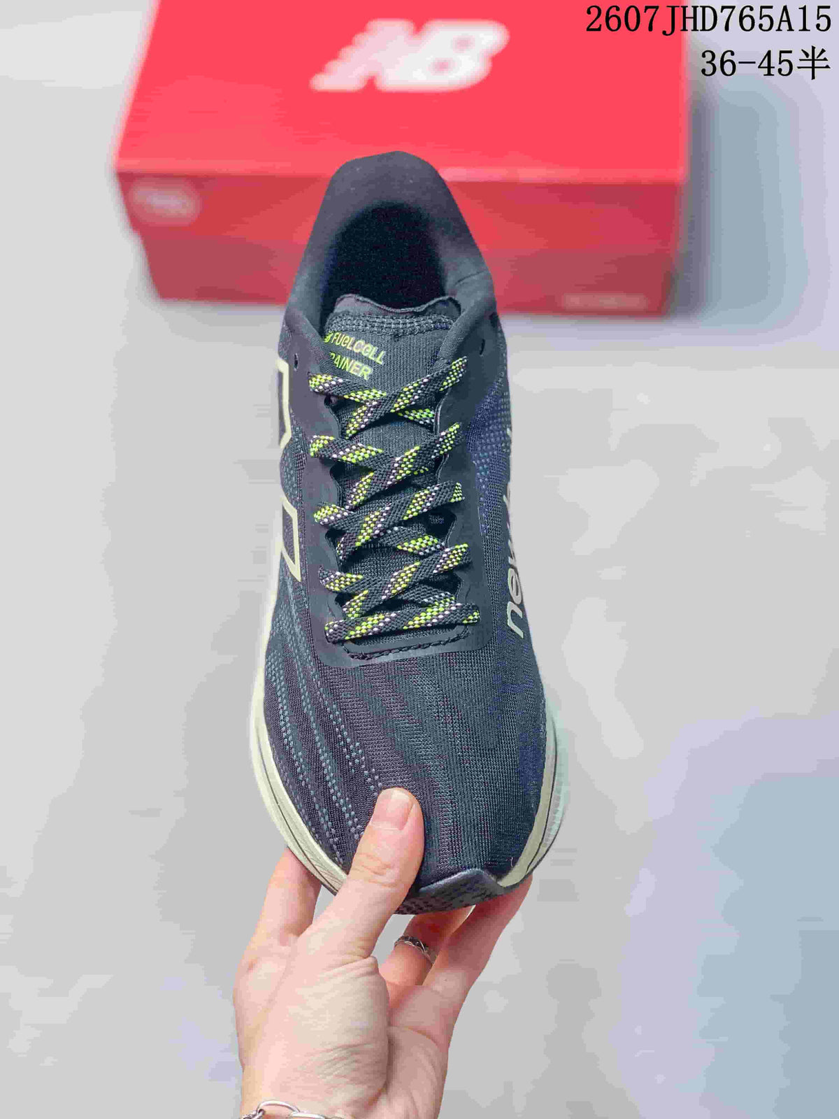 Top view of the New Balance RC Elite shoe showing the dark navy mesh upper and black-and-neon patterned laces.