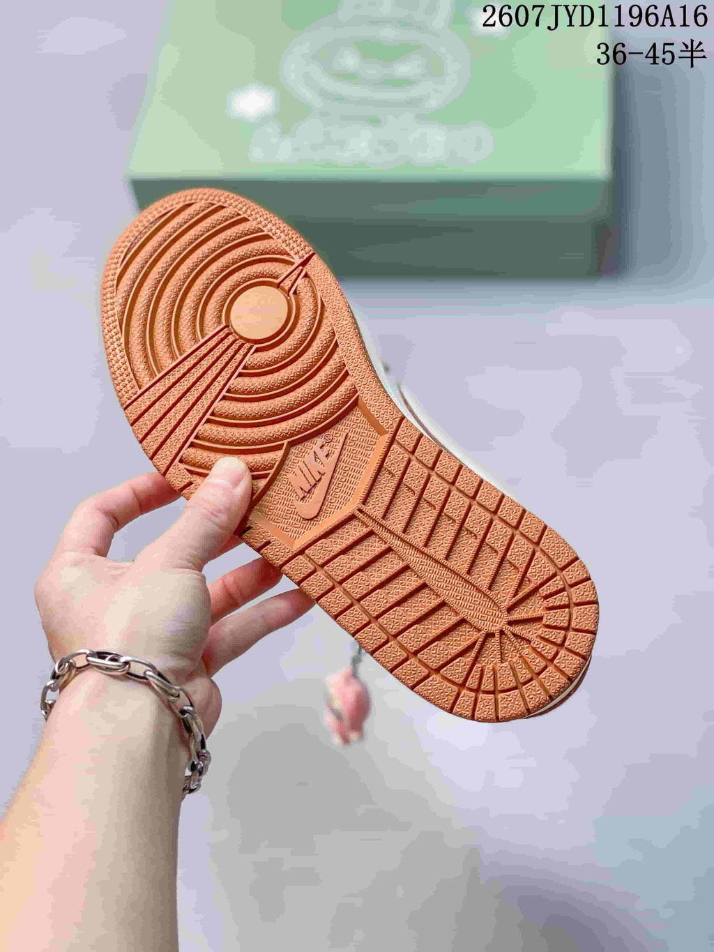 Close-up of the brown textured outsole showing circular traction and patterned tread sections.