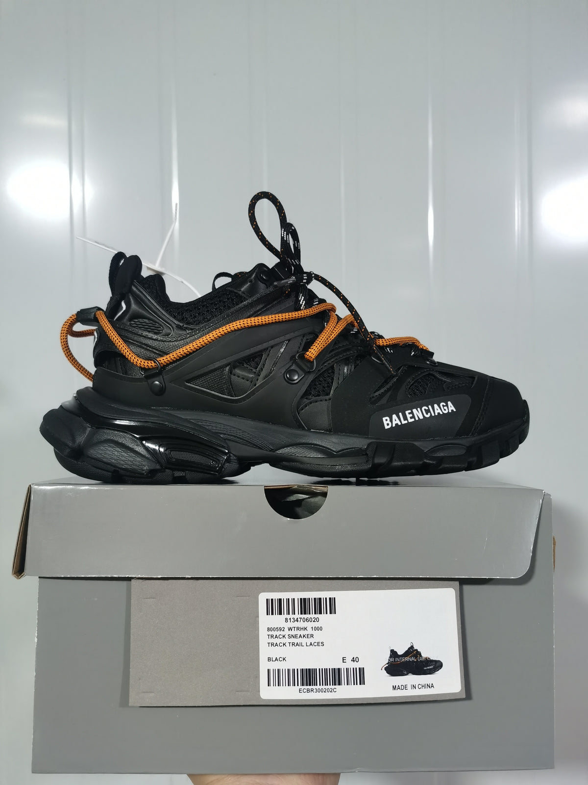 Side view of the black Balenciaga Track sneaker displayed on its box; the box label shows size E 40 and track sneaker product text.