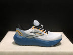 Side profile of a Brooks Glycerin 21 sneaker showing the white upper, blue midsole, black outsole edge, and Glycerin branding.