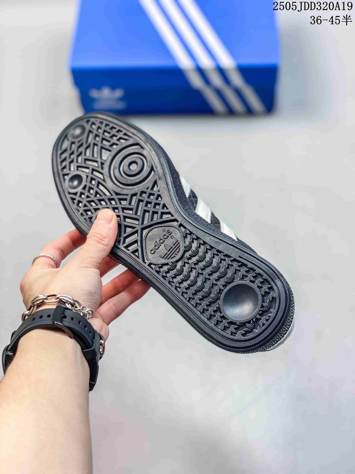 Close-up of the black textured rubber outsole with circular and geometric tread patterns.