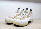 Front three-quarter view of white Air Foamposite One sneakers with marbled beige overlays and white laces.